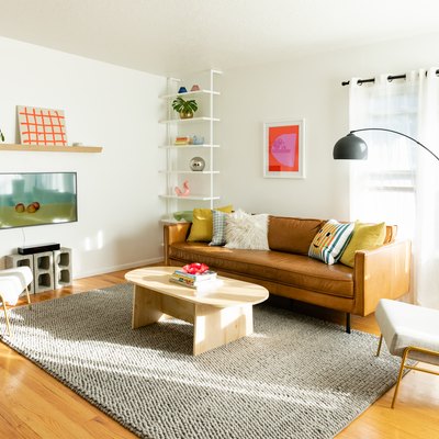living room with simple decor on the walls, mid-century modern decor and hardwood floors