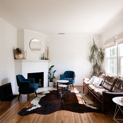 living room with cowhide rug on hardwood floor