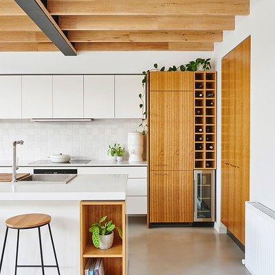 concrete kitchen flooring and exposed wood ceiling beams