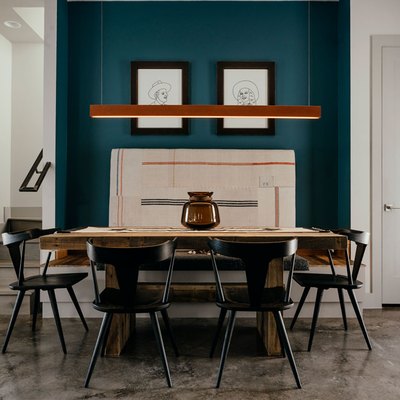 dining room with concrete floor and teal accent wall