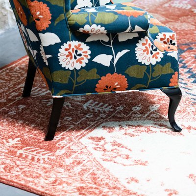 accent chair on faded Moroccan design carpet