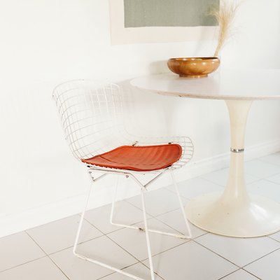 white tile floor in kitchen, tulip table, bertoia chairs