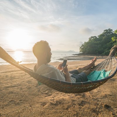 Texting from a hammock on the beach