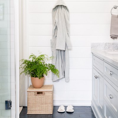 close up on robe in bathroom with blue tiled floor