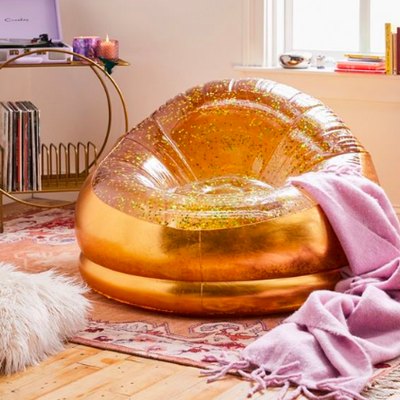 gold inflatable chair with purple blanket