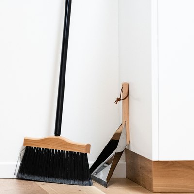 Broom and dust pan on wood floor