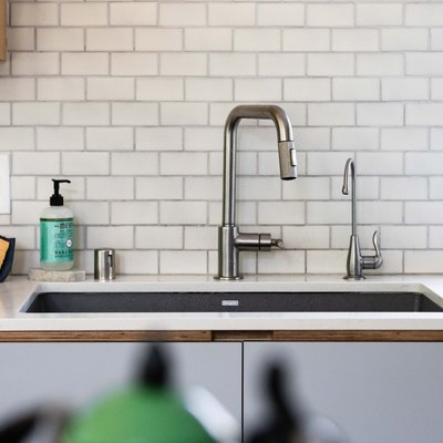 kitchen faucet against subway tile backsplash