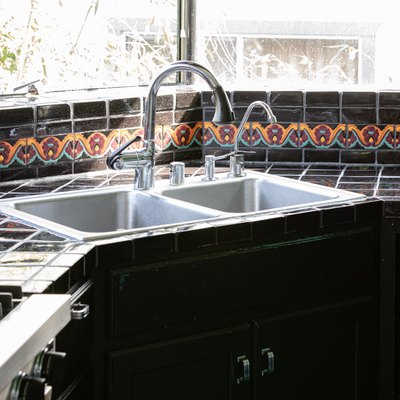 corner kitchen sink with black tile