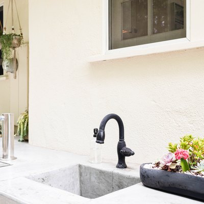 outdoor kitchen sink with black faucet