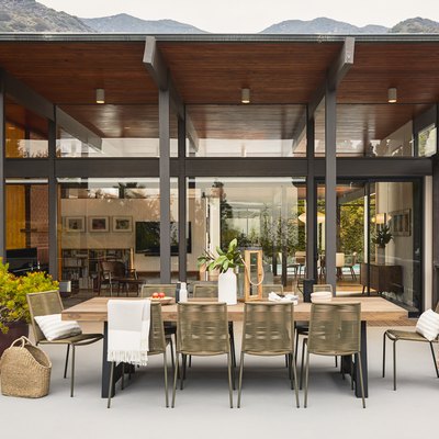 table and chairs outdoors with person near the left