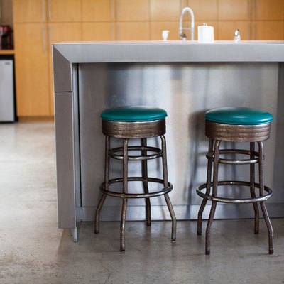 stainless steel kitchen island with two barstools