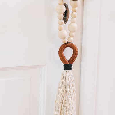 Tassel and beads hung on door