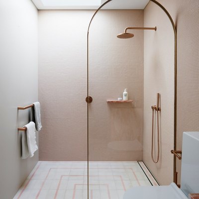 pink and white bathroom with floating shower storage ideas