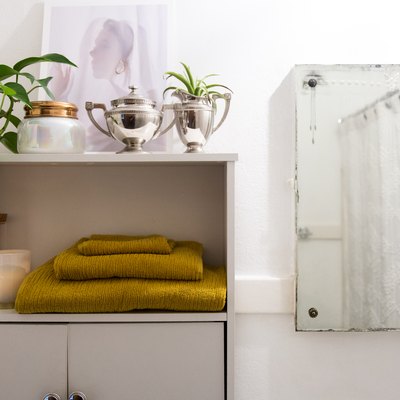 bathroom storage cabinet with plants, decorations and towels