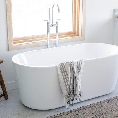 stand alone tub in front of a window