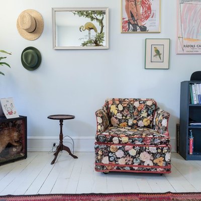 eclectic seating area with grandma style chair and mosaic picture wall