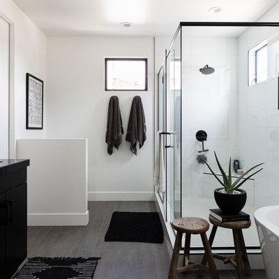 white bathroom, glass shower with light fixture above