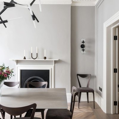 soft gray neutral colors in dining room with fireplace and white mantel