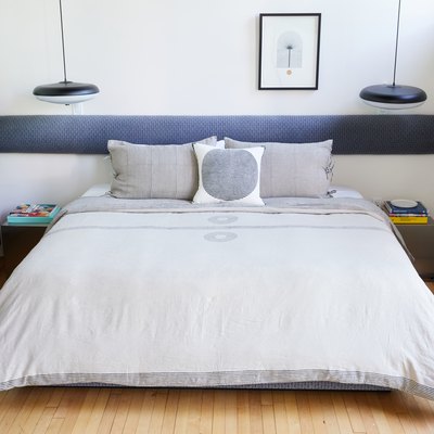 bed with two lighting fixtures on either side