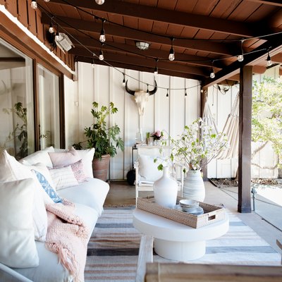 Covered outdoor patio area with bohemian decor