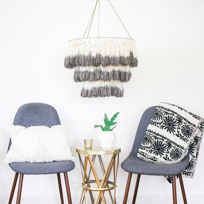 Tassel chandelier hanging above two chairs
