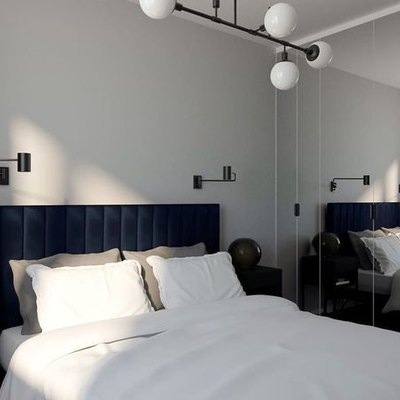 modern IKEA bedroom idea with articulating wall sconces and channel-tufted headboard