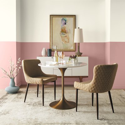 dining area with artwork and half-painted wall