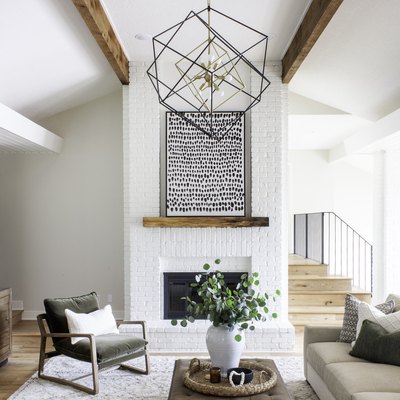 ivory color idea in sitting room with painted fireplace and modern light fixture