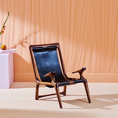 chair near orange curtain and purple table
