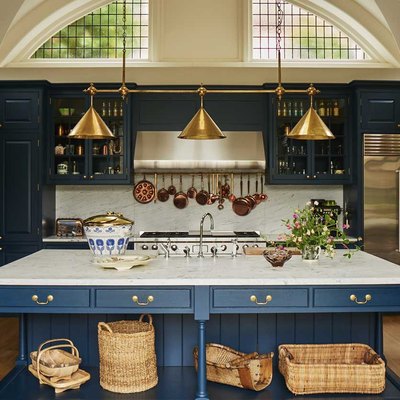 arts and crafts kitchen with blue island and brass light fixture