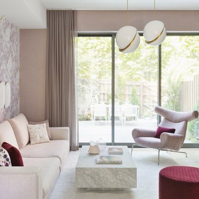 pink room ideas with Pink couch, pink lounge chair, red pouf, marble coffee table, pink walls, pink wallpaper, pink curtains, white pendants lights.