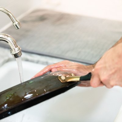 Washing pan in kitchen sink.