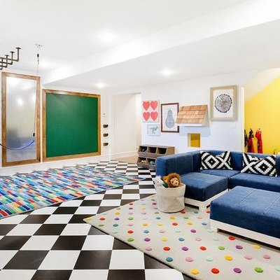 basement ideas with Black and white checker floors, multi colored area rug, navy blue sectional, yellow accent wall, chalkboard, climbing wall and ceiling.