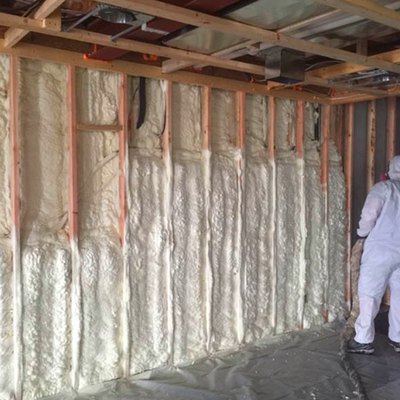 Spraying foam insulation in the basement.