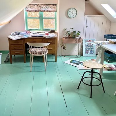 Home Office for Two Attic office with painted turquoise wood floors, vintage desk, stool, wall clock.