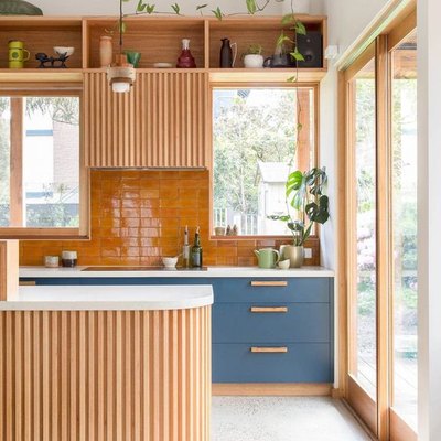 wooden kitchen cabinetry with cantaloupe orange tiling