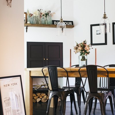 industrial dining room idea with iron chairs and exposed glass lighting