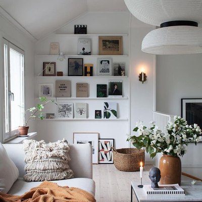 Scandinavian living room with open shelving and statement chandelier