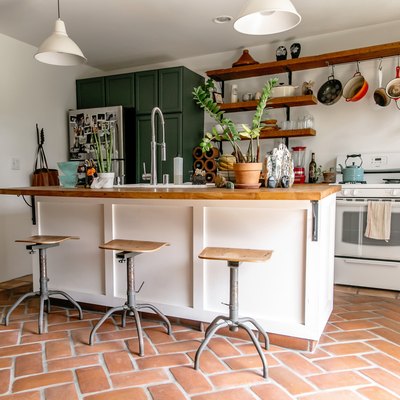 Clay tile floor in kitchen with bar stools