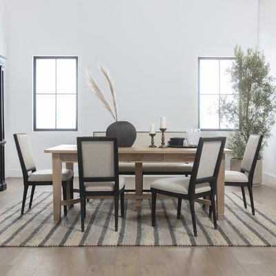 dining room area with wood table and striped rug