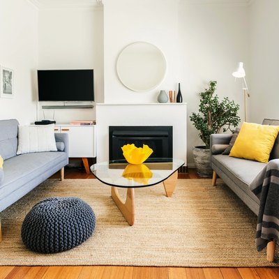 living room space with grey couches and white walls