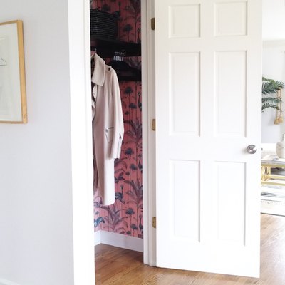 hallway closet storage idea with woven baskets on shelf and matching hangers