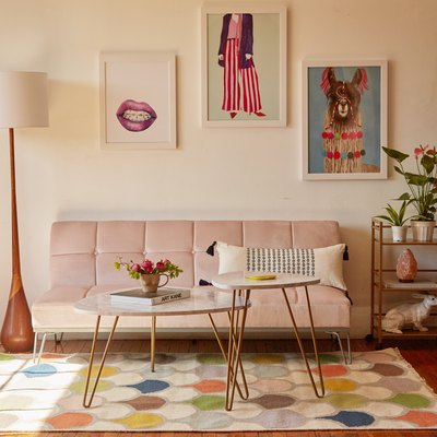living room with pink futon and wall art
