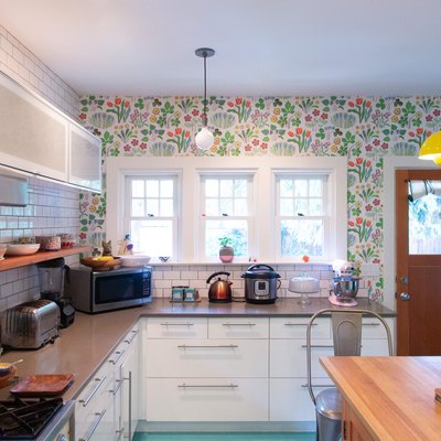 kitchen with floral wallpaper and subway tile backsplash