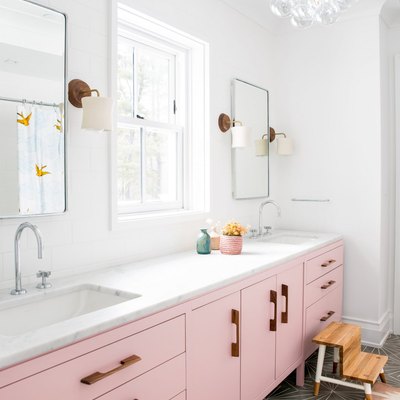 kids bathroom idea with pink vanity and cement floor tile