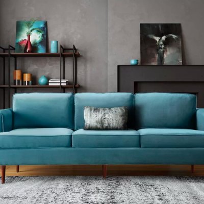 blue couch in living room near shelf