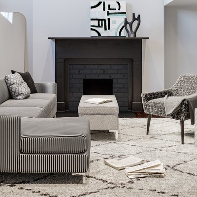 living room with patterned furniture and black fireplace