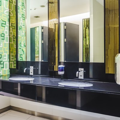 New modern restroom with touch-free automatic sensor faucets.