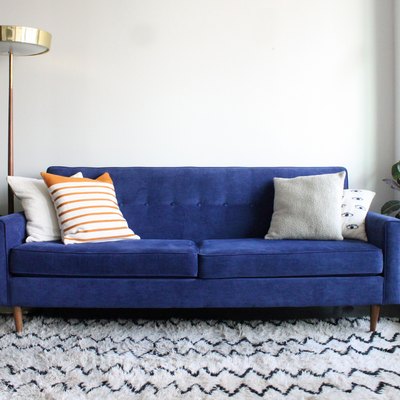 Blue Suede Mid Century Modern Couch in Minimalist Apartment Setting