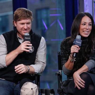 Chip and Joanna Gaines sitting in chairs holding microphones